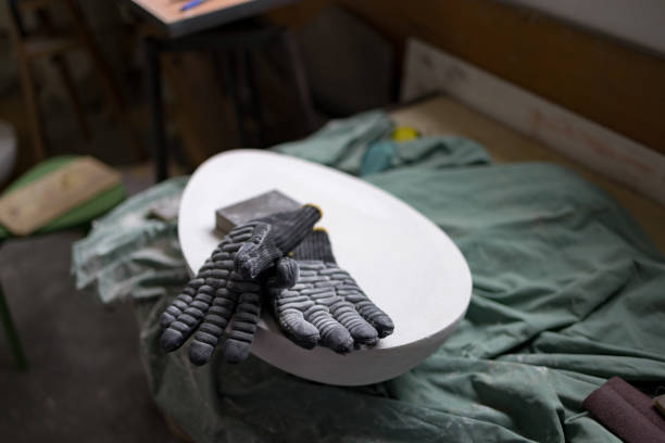 Close up of protective gloves on a sculpture in an art studio.