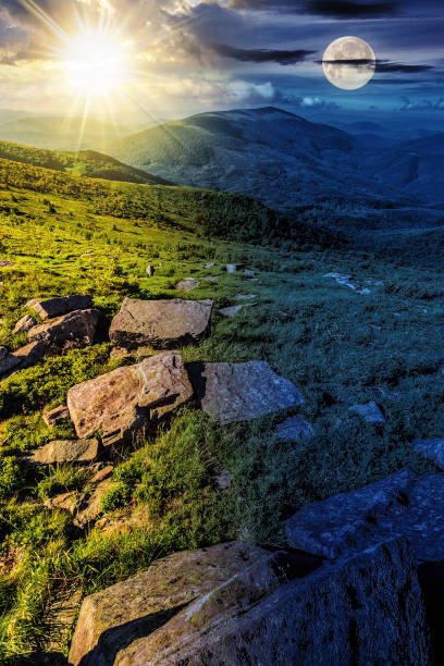 istock mountain summer landscape with sun and moon at twilight 1740570639