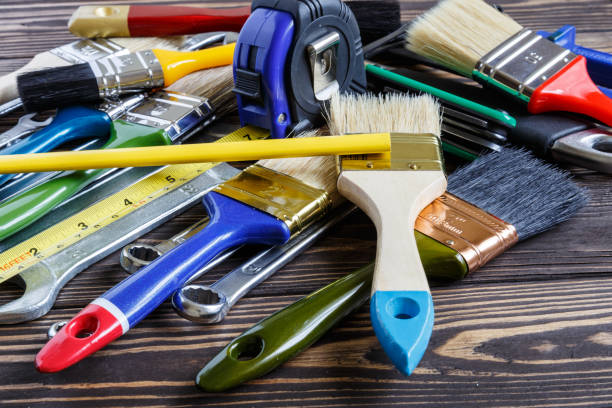 istock Painter and decorator work table with house project, color swatches, and paint brushes 1740570693