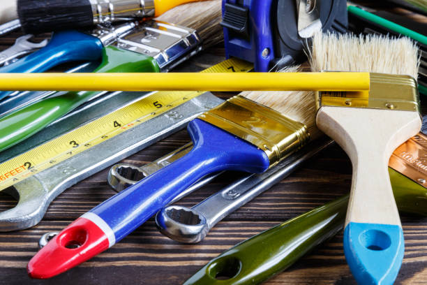 istock Painter and decorator work table with house project, color swatches, and paint brushes 1740570699