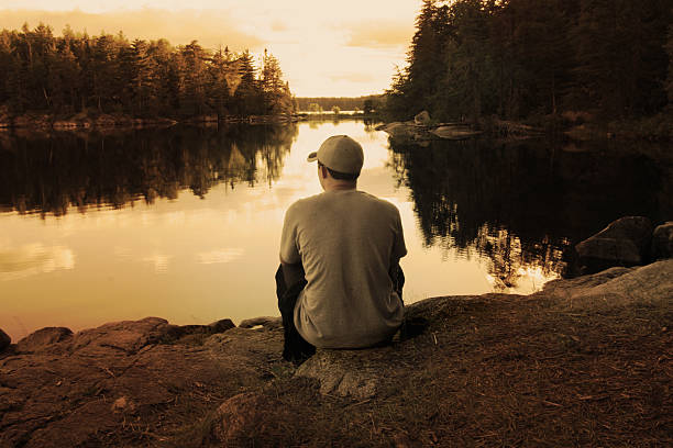istock Boy enjoying sunset on Boundary Waters lake 174058496