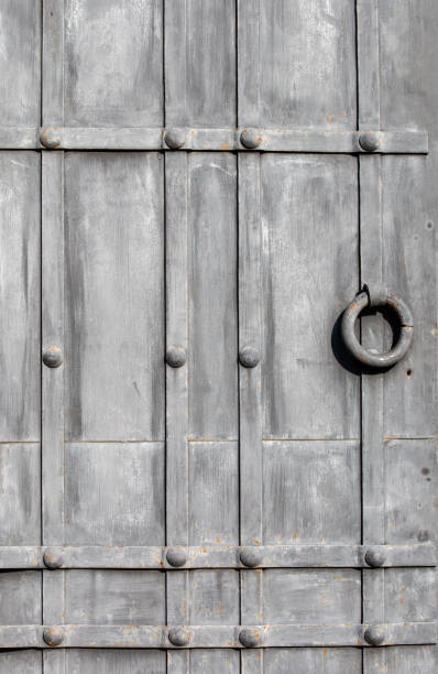 istock gray wooden door with ring close up 1740603552