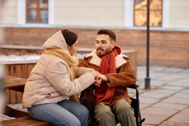 istock Couple with disability chatting during winter date 1740607374