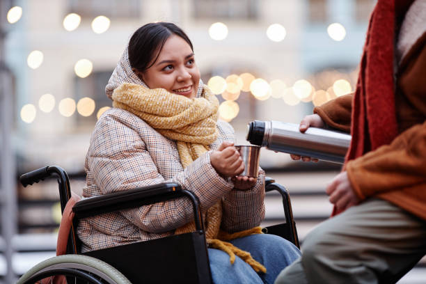 istock Young woman with disability sharing hot drinks with boyfriend on date 1740607938
