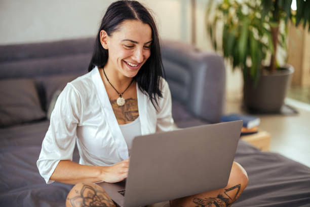 istock Young woman uses laptop in bed 1740611769