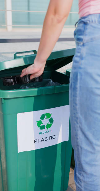istock woman trash in recycle bins 1740616540