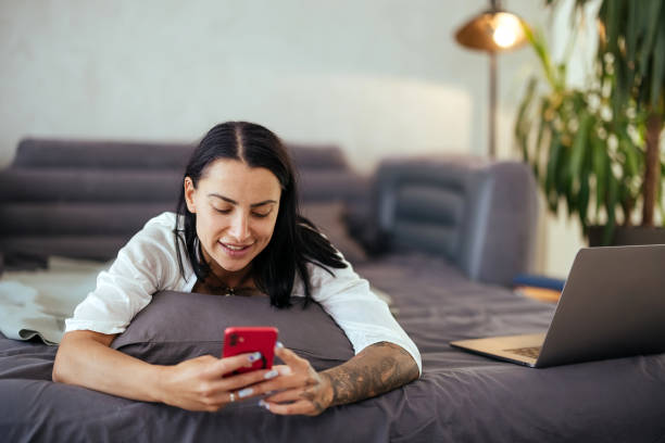 istock Woman using smart phone in bed in the morning 1740617650