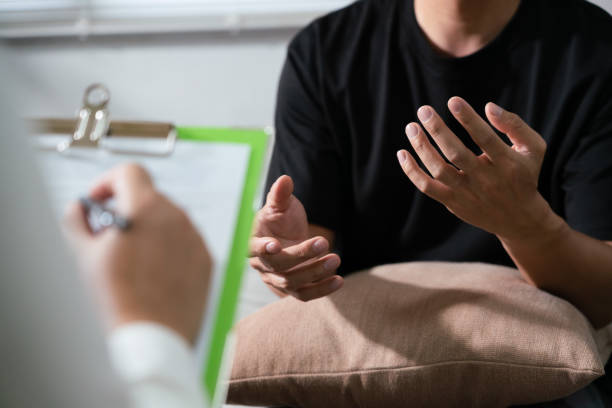 istock Psychologist is diagnostic examination and taking note while talking with man mental health problem 1740625840