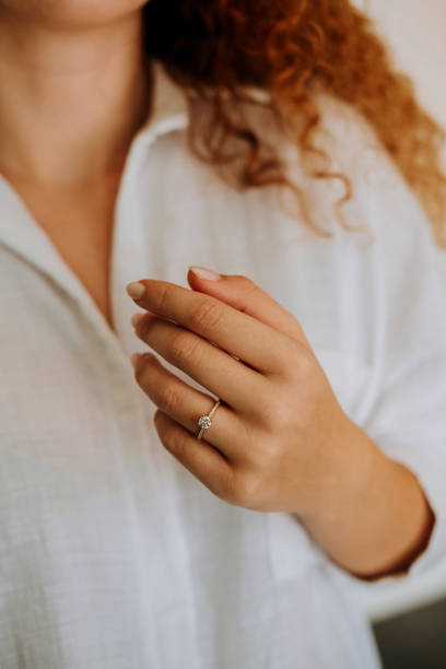 istock Woman wearing a diamond ring on her finger. 1740629326