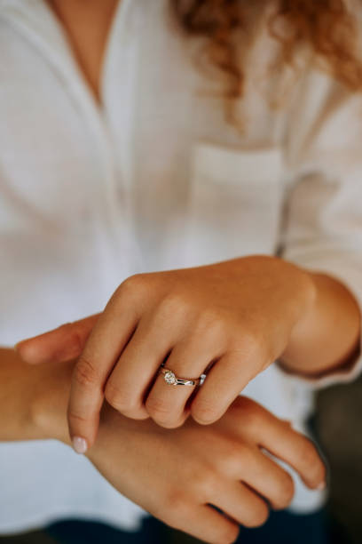 istock Woman wearing a diamond ring on her finger. 1740629327