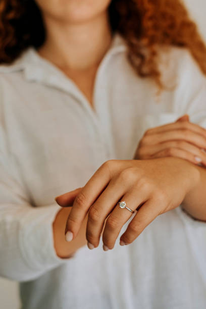 istock Woman wearing a diamond ring on her finger. 1740629331