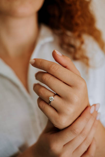 istock Woman wearing a diamond ring on her finger. 1740629393