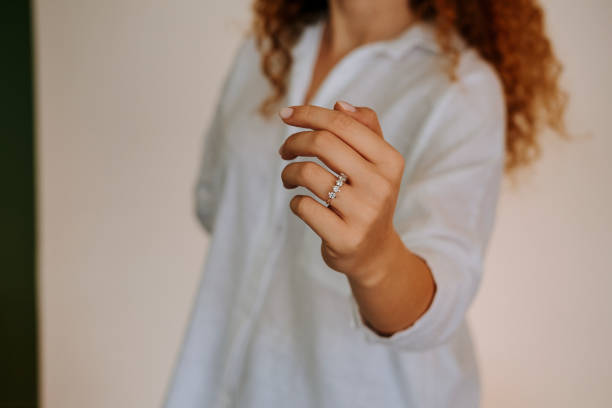 istock Woman wearing a diamond ring on her finger. 1740629642