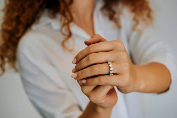 istock Woman wearing a diamond ring on her finger. 1740629844