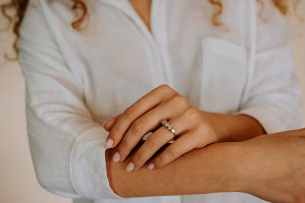 istock Woman wearing a diamond ring on her finger. 1740629850