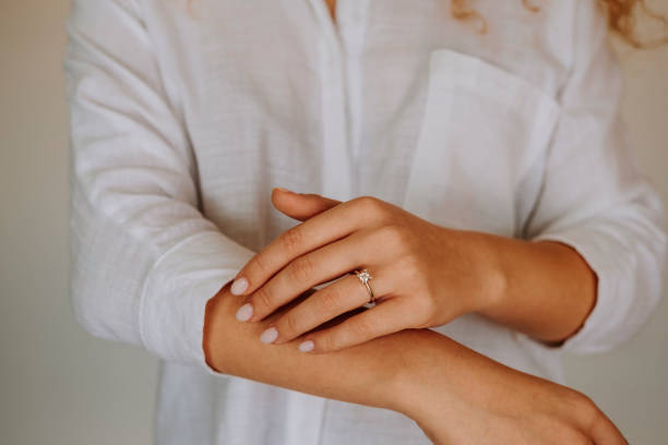 istock Woman wearing a diamond ring on her finger. 1740629854
