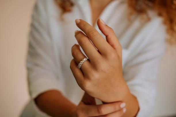 istock Woman wearing a diamond ring on her finger. 1740629855