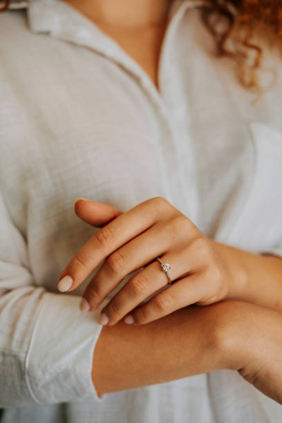 istock Woman wearing a diamond ring on her finger. 1740629858