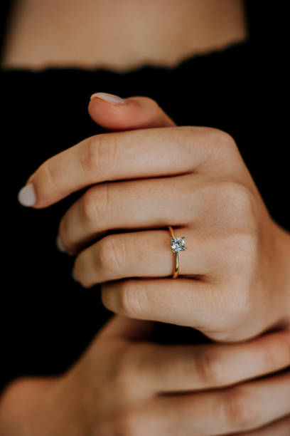 istock Woman wearing a diamond ring on her finger. 1740629863