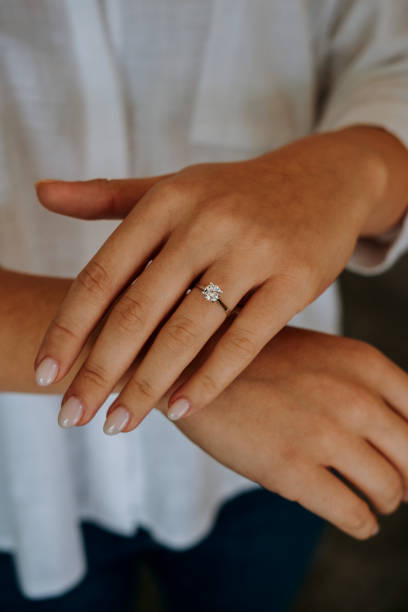 istock Woman wearing a diamond ring on her finger. 1740629870