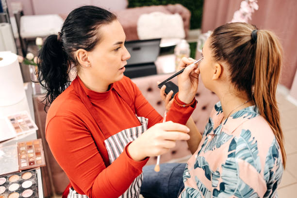 istock Young woman doing makeup in beauty salon 1740643839