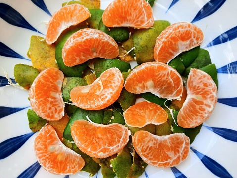 Orange fruit and peels - white background.