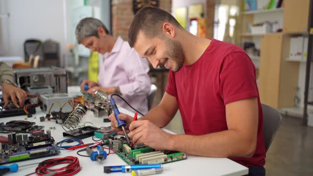 Man repairing a broken computer motherboard