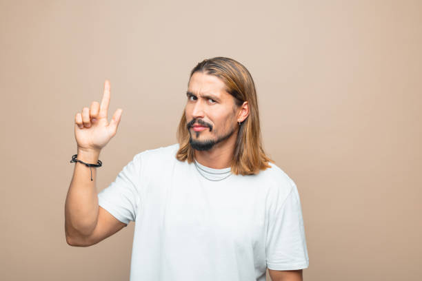 istock Portrait of confused man pointing at copy space 1740666023