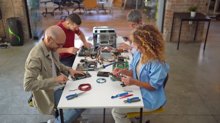 Group of people repair computer components