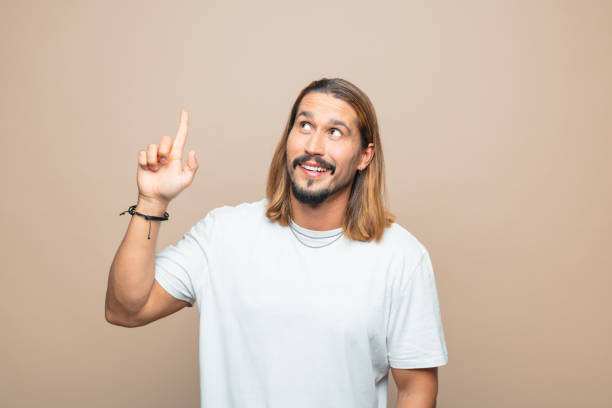 istock Portrait of excited man pointing at copy space 1740668739