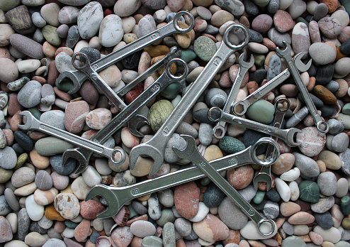 Different Iron Wrenches On A Sea Stones