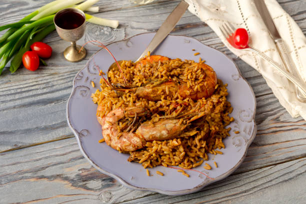 Seafood. Pilaf from large shrimps with spices on a wooden table close-up