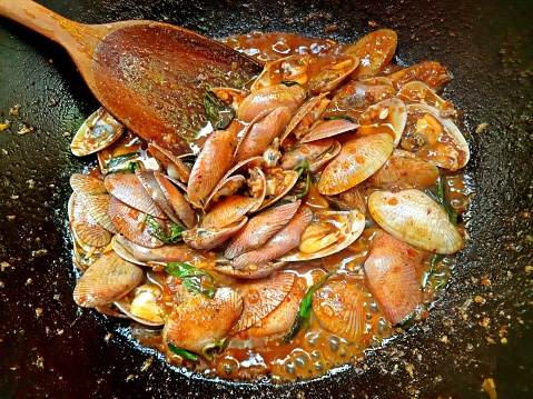 Cooking Stir Fried Clams with Chili Paste - Thai food preparation.