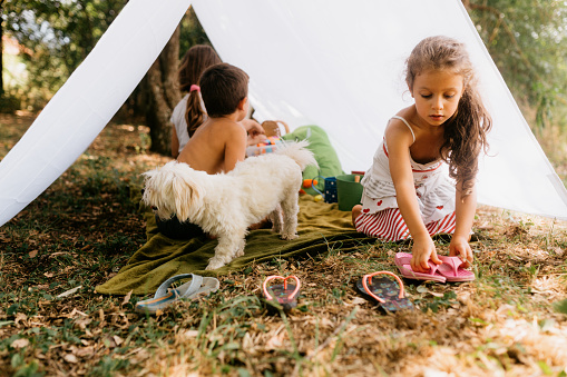 Children playing camping in the yard and having fun