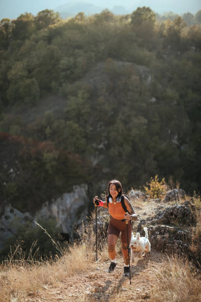 istock Woman hiking with her dog 1740686227