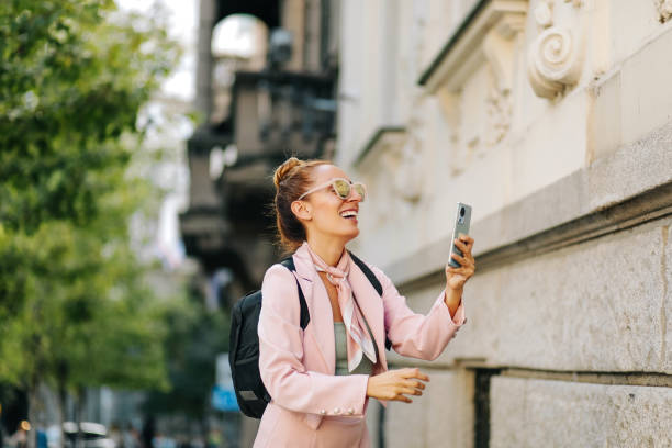 Elegant beautiful woman standing with smart phone Elegant beautiful woman standing with smart phone victoria house stock pictures, royalty-free photos & images