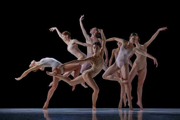 istock Tender, elegant young people, ballet dancers making beautiful performance on stage against black background. 1740699286