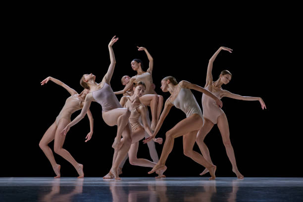 istock Tender, elegant young people, ballet dancers making beautiful performance on stage against black background. 1740699326