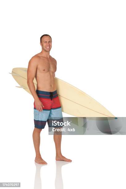 Attractive Man Carrying A Surfboard Stock Photo - Download Image Now - 30-39 Years, Adult, Adults Only