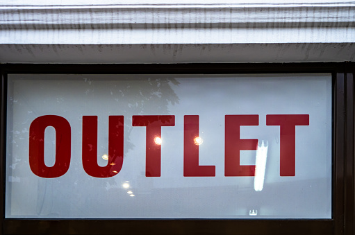 Outlet sale signage shopfront window display.