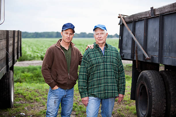 istock Men working on a potato farm, with trucks 174070697