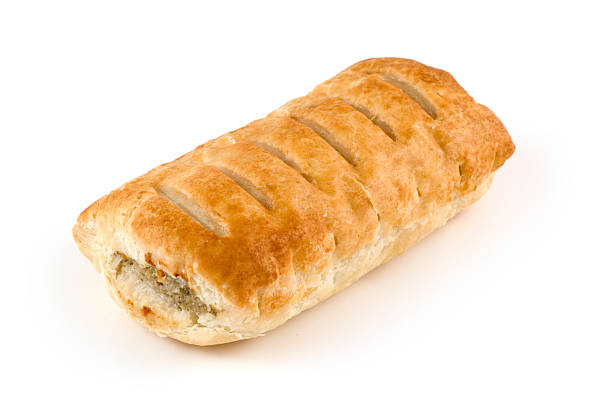 Toasted sausage roll on white background A sausage roll on a white background. sausage roll stock pictures, royalty-free photos & images