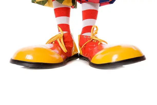 Clown legs and feet isolated on white.