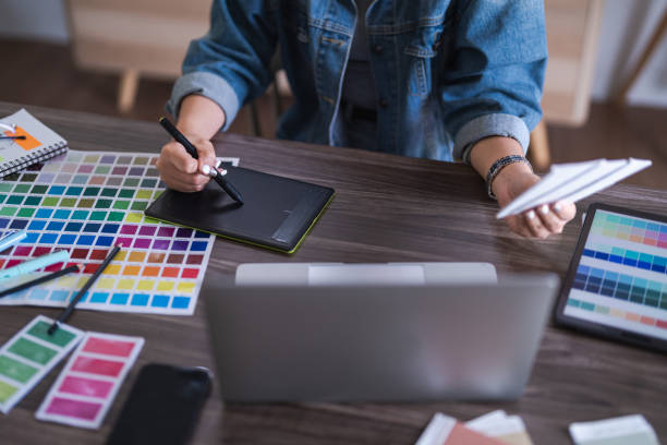 istock Graphic designer women working on digital tablet while selection color to designing graphic design 1740718245