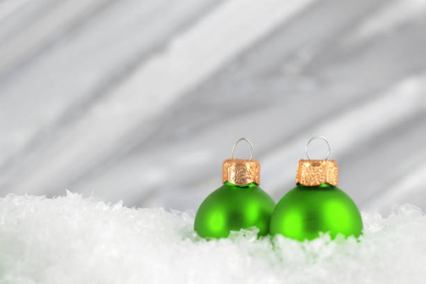 istock green Christmas baubles on snow 174071972