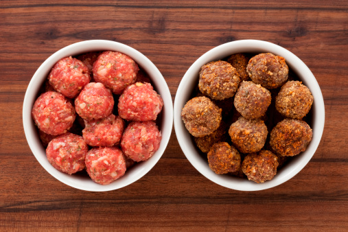 Top view of two white bowls with meatballs. Raw on the left and fried on the right for food processing concept