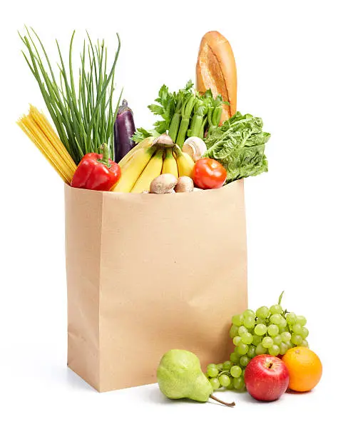 paper bag full of groceries isolated on white
