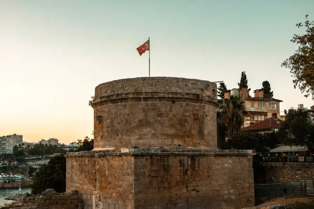 Photo of Hidirlik Tower is a symbolic tower made of yellowish brown stone in Antalya, where Kaleici meets Karaalioglu Park.