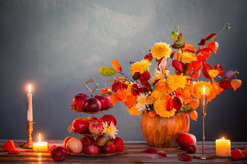 beautiful autumnal  bouquet on wooden table on dark wall