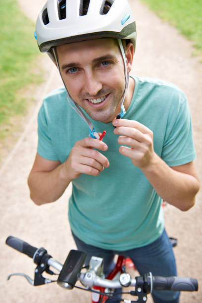 istock Man Fastening Strap Of Cycle Helmet 174073128